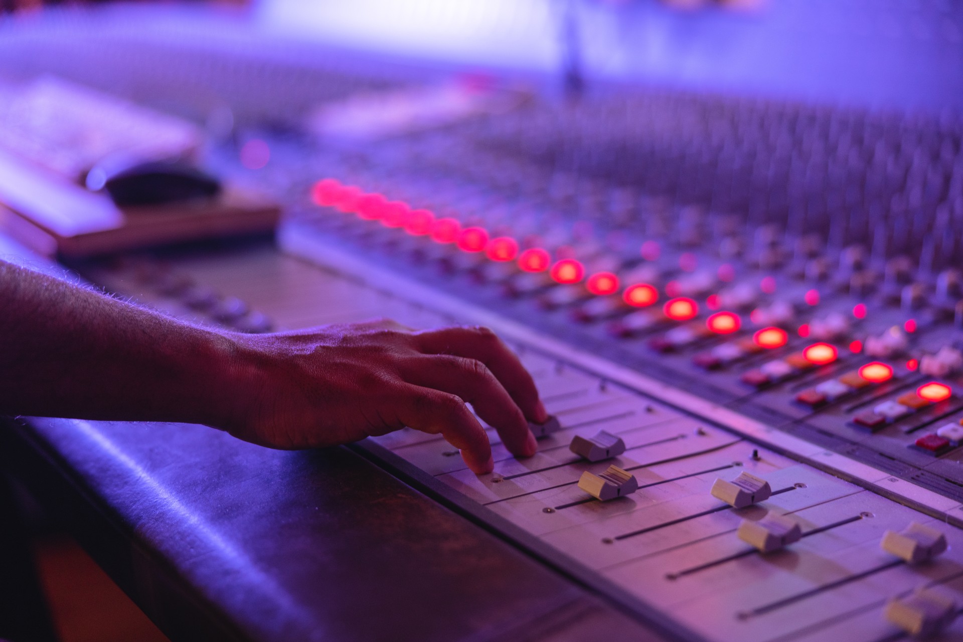 Hands Of A Black Male Sound Engineer Adjusting The Sounds On A Digital Mixing Console Board